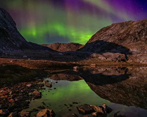 Icefjord Prints: Northern Lights reflection in a pond during full moon at the Sermilik (Sermiligaaq) Icefjord in East Greenland