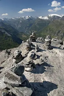Cove Prints: Norway, Geiranger. Travelers stone stacks with a view of the port of Geiranger from Mt