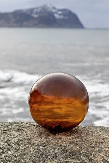 Images Dated 26th September 2022: Norway, Lofoten Islands, Vareid. Mountains and ocean viewed through a glass ball