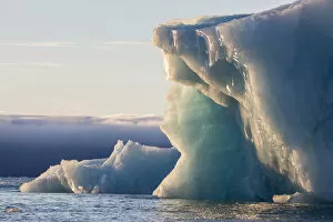 Norway Collection: Norway, Svalbard, Kvitoya. Iceberg and fog bank at sunrise