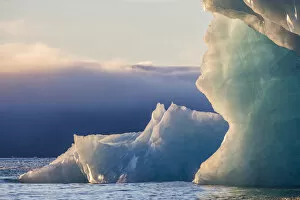 Norway Collection: Norway, Svalbard, Kvitoya. Iceberg and fog bank at sunrise
