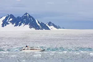 Norway, Svalbard, Spitsbergen, Cruise Ship MV Columbus motoring past blue ice face