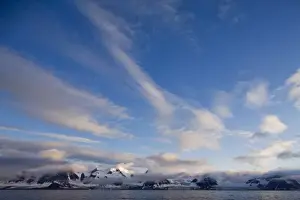 Day Light Prints: Norway, Svalbard, Spitsbergen, Setting sun lights clouds above glacier-covered mountains