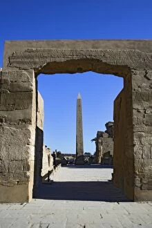 Obelisk of Thutmose I framed by doorway covered in hieroglyphs, Temple of Karnak