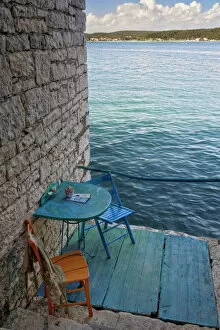Images Dated 29th April 2008: Oceanside seating for two at tiny outdoor cafe, Rovigno, Croatia