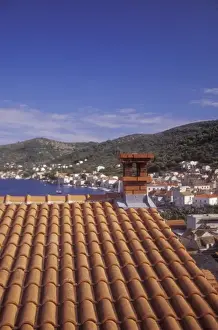 Historic Town Prints: An ochre colored roof of a house up on a hill on the western side of town provides
