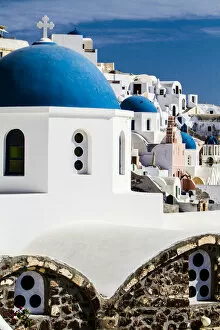Greece Gallery: Oia, Greece. Row of Greek Orthdox Churches with blue domes and painted pastel white