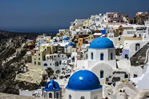 Jolly Sienda Prints: Oia, Santorini, Greece. Blue dome Greek Orthodox churches, white washed and colored