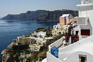 Oia, Santorini, Greece. Village of Oia with blue and red wooden gates and painted