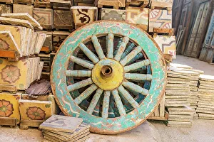 Decorative Prints: Old Cairo, Cairo, Egypt. Wooden cart wheel and floor tiles in an alley in Cairo