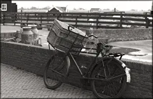 Old Fashion Prints: An old fashioned bike with basket leaning again brick wall on an old farm