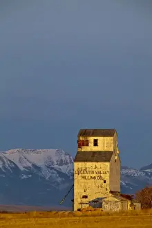 Granary Prints: Old Gallatin Valley Mill Granary with the Rocky Mountains in background near Choteau