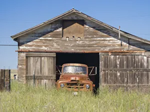 Truck Prints: Old orange truck in an old garage