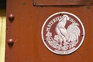 Old red wine press with a sign Materiel Coq with a French cock symbol Domaine la Tourade