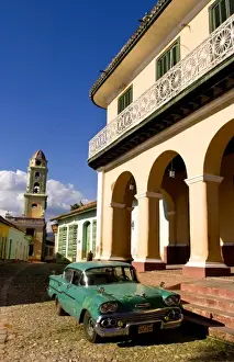 Chevrolet Prints: Old worn 1958 Classic Chevy on cobblestone street in center square of Trinidad Cuba