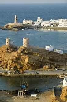 Oman, Sharqiya Region, Sur. Towers of Al Ayajh Fort / Sur Bay / Late Afternoon