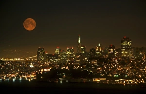 Marin Headland Prints: An orange full moon rises over the San Francisco cityscape