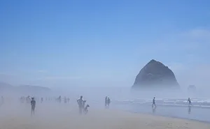 Surreal Prints: Oregon, Cannon Beach. Haystack Rock, beachgoers in fog