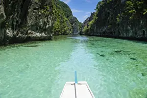 Bacuit Prints: Front of an outrigger boat in the crystal clear water in the Bacuit archipelago, Palawan