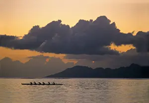 James Kay Prints: An outrigger canoe team practices off the coast of the island of Tahiti as the sun