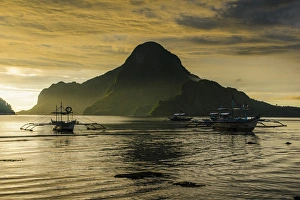 Bacuit Prints: Outrigger at sunset in the bay of El Nido, Bacuit Archipelago, Palawan, Philippines