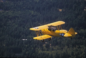 P. R. Yellow Biplane, 1944 Stearman PT-17, flying over Puget Sound, WA