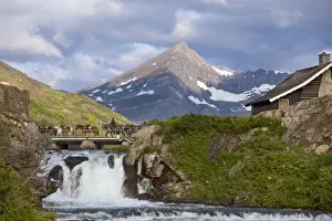 Images Dated 10th July 2009: Packers lead string of horses over bridge above Swiftcurrent Falls in the Many Glacier