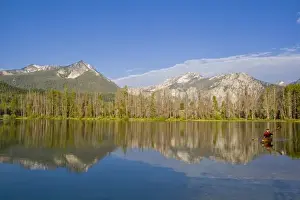 Sea Kayak Prints: Paddling a sea kayak on a calm Pettit Lake in the Sawtooth Mountains of Idaho (MR)