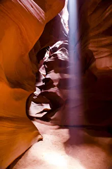 Navajo Prints: Page, Arizona. Upper Antelope Canyon. Ray of light streams down from the open slot