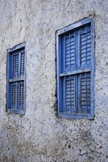 Pair of blue windows in alley, rural village outside Luxor, Egypt