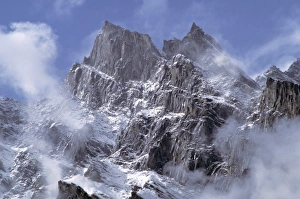 Jagged Prints: Pakistan, N-W Frontier Province, Naltar Valley. Clouds rise above the jagged flank