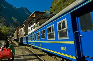Images Dated 25th July 2010: Passenger trains run right down the main street of the small village of Aguas Calientes