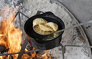 Patagonia Argentina. Empanadas are being cooked in oil; here removed with a colander
