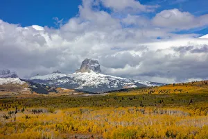 Sacred Prints: Peak fall color in aspen groves below Chief Mountain in Glacier National Park, Montana