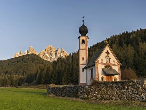 The peaks of the Geisler mountain range in valley Villnoess. The church Sankt Johann in Ranui (St