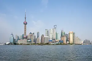 Pearl Tower over Pudong district skyline and Huangpu River Shanghai, China