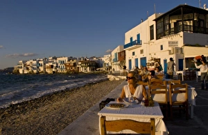 Images Dated 27th January 2010: People eating at a restaurant near the beach at Little Venice, Mykonos (MR)