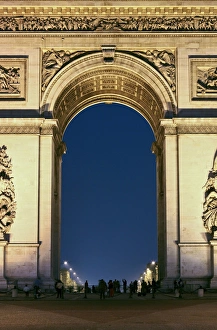 Napoleon Prints: People standing under the Arc de Triomphe at night, Paris, France