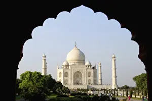 Photograph through a doorway showing sunrise at the famous Taj Mahal one of the wonders
