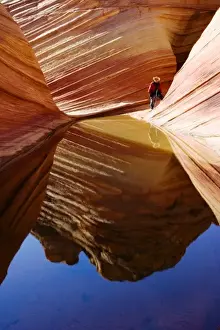 Terrain Prints: A photographer at the Wave in the Paria Canyon-Vermilion Cliffs wilderness area (MR)
