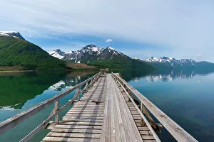 Boardwalk Prints: A pier on Holandsfjorden, rimmed with ice streaked mountains