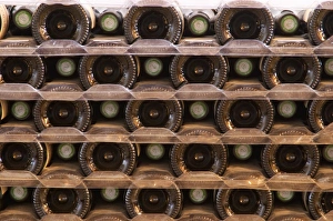 A pile of bottles stacked high with the bottle bottoms and bottle necks. Tax stamp A pile of bottles stacked high with the bottle bottoms and bottle necks. Tax stamp