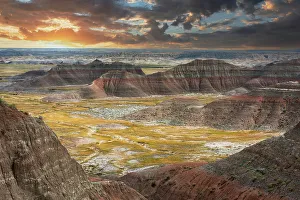 Badland Prints: The pink striped peaks or hoodoos are layered with a grass valley, at sunset