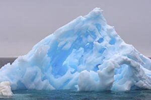pinnacle iceberg floating off the western Antarctic peninsula, Antarctica, Southern Ocean