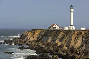 Point Arena lighthouse on cliffs over the Pacific Ocean near Point Arena, California, USA