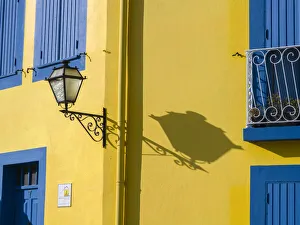 Aveiro Prints: Portugal, Aveiro. Shadow of street lantern on colorful yellow building with bright blue