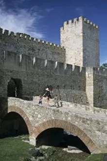 Portugal, Lisbon, Mother and children cross over moat to Castelo (castle) de Sao Jorge