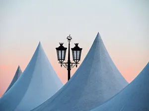 Lisbon Prints: Portugal, Lisbon. Street lamp and top of artist tents at dusk in Commerce Square (Praca do Comercio)