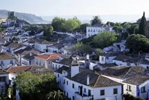 Portugal, Obidos. Elevated view of whitewashed houses and 14th century crenellated walls of castle