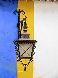 Iberian Peninsula Prints: Portugal, Obidos. Wrought iron lantern hanging from a colorful stripped wall in the walled town